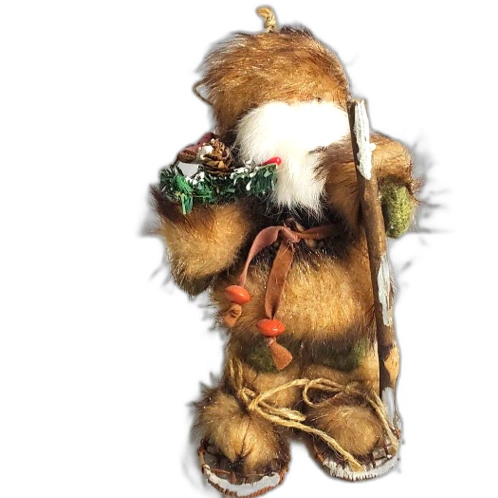Furry Santa Claus with SnowShoes on and Holding a Pink Fish